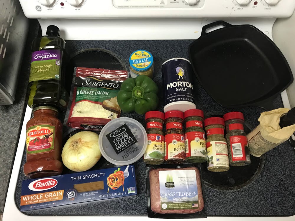 All of the ingredients necessary for pasta with meat sauce.