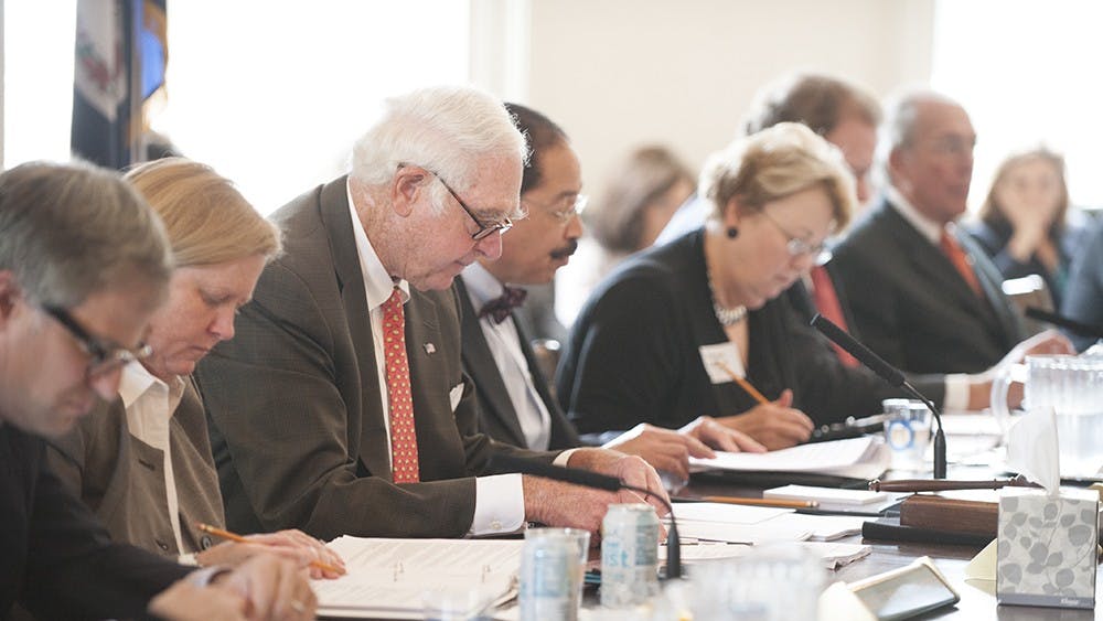 Members of the Board of Visitors, including Rector George Martin, above center, met in the Rotunda.