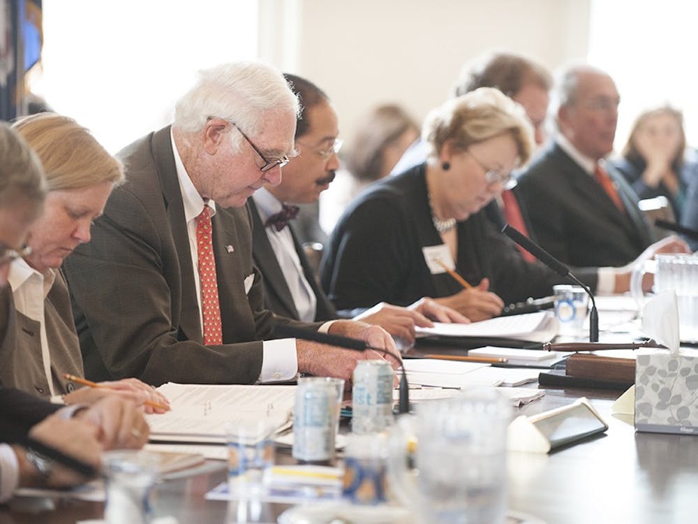 Members of the Board of Visitors, including Rector George Martin, above center, met in the Rotunda.