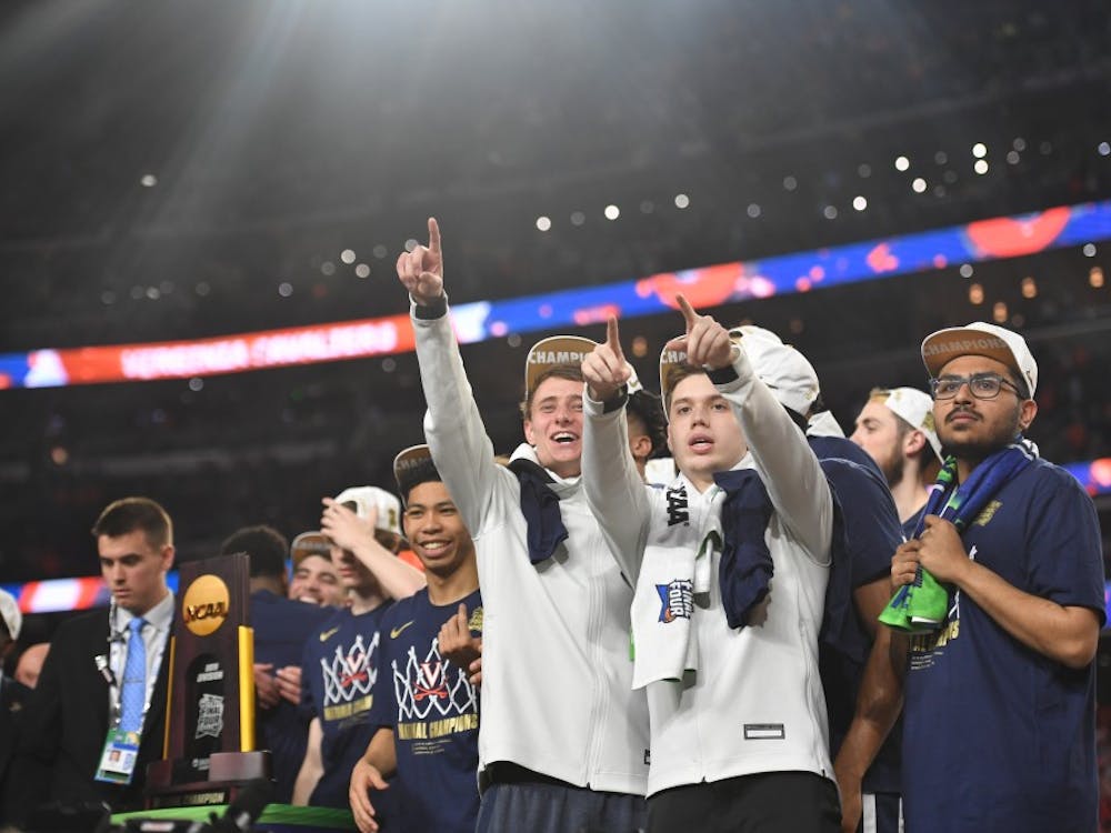 Senior student managers Grant Kersey, Justin Maxey and Faris Wasim celebrate Virginia's first National Championship in program history in Minneapolis.