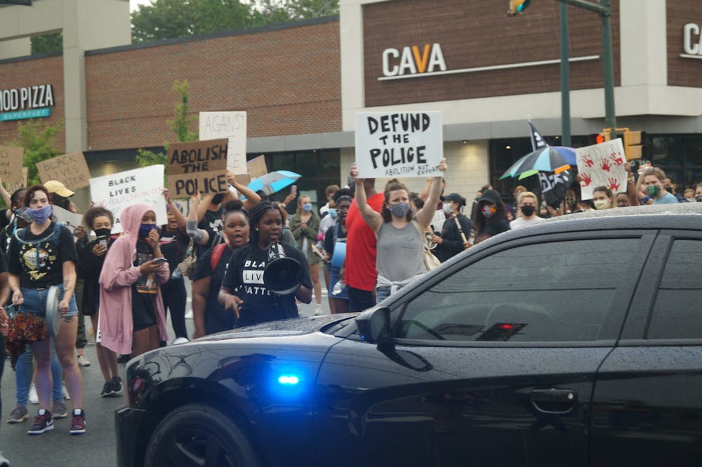 Led by a group of local black women, hundreds of community members gathered in the John Paul Jones Arena parking lot Saturday evening as part of the Defund the Police Block Party and Noise Demonstration. (CD Photo // Sophie Roehse)