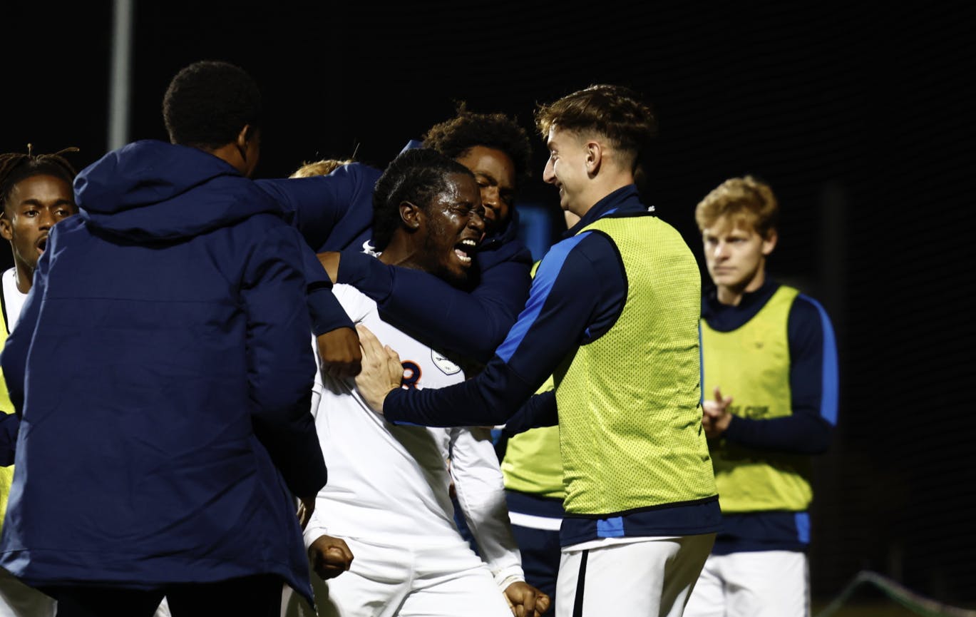 Kome Ubogu is engulfed by teammates after scoring one of his two goals.