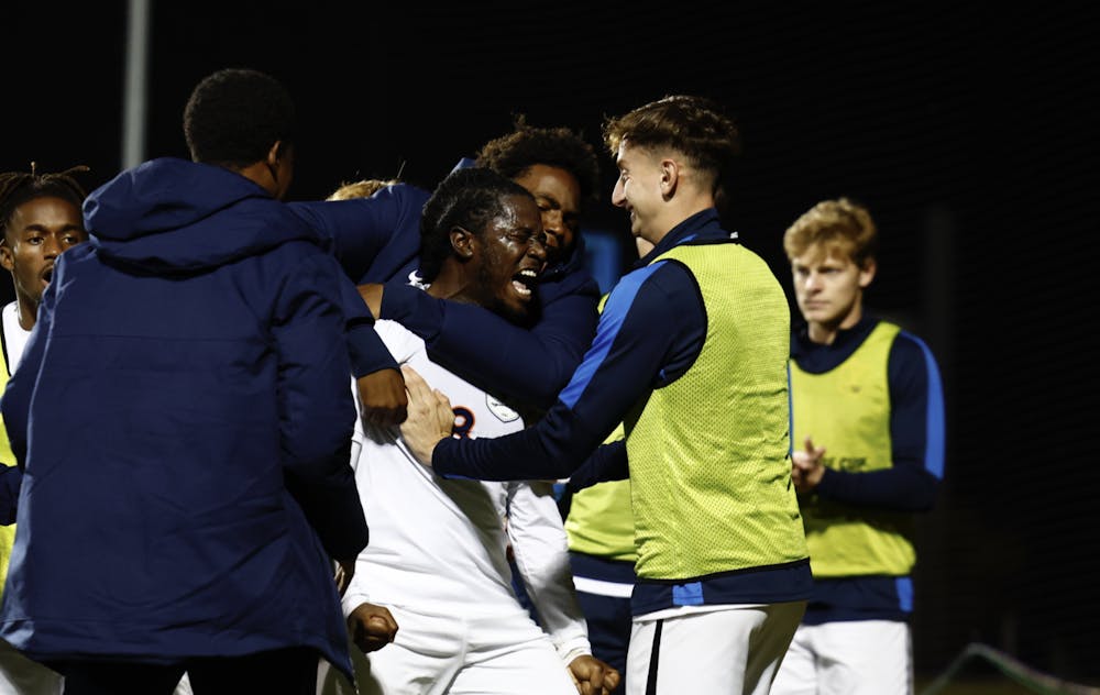 <p>Kome Ubogu is engulfed by teammates after scoring one of his two goals.</p>