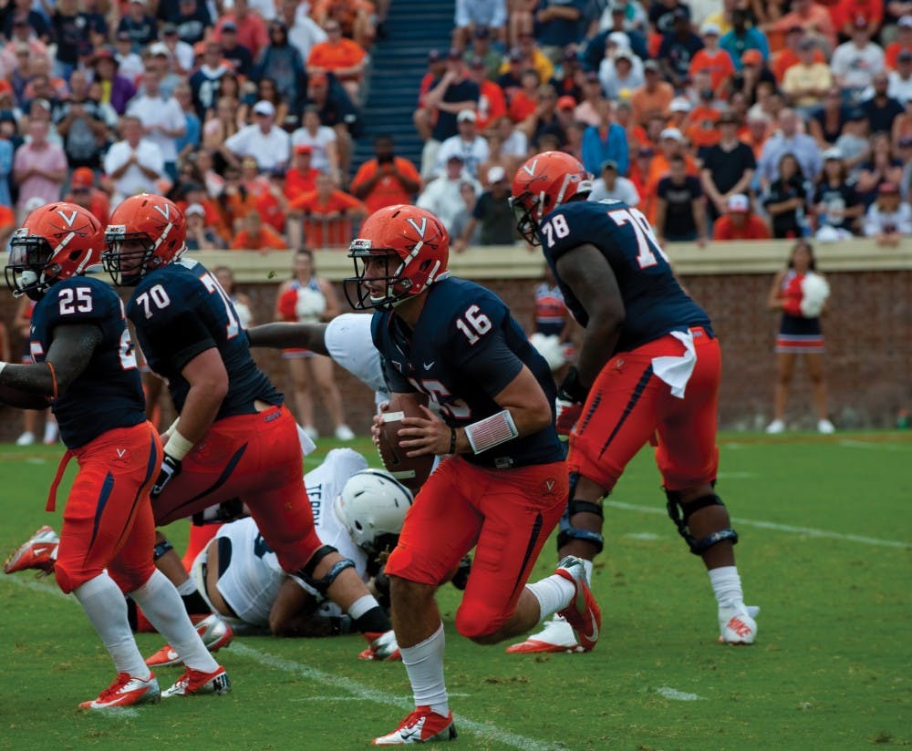 	Junior quarterback Michael Rocco eludes the pass rush in a Sept. 8 game against Penn State. Rocco endured extensive scrutiny this week after throwing two interceptions in a humiliating 56-20 loss to Georgia Tech Saturday.
