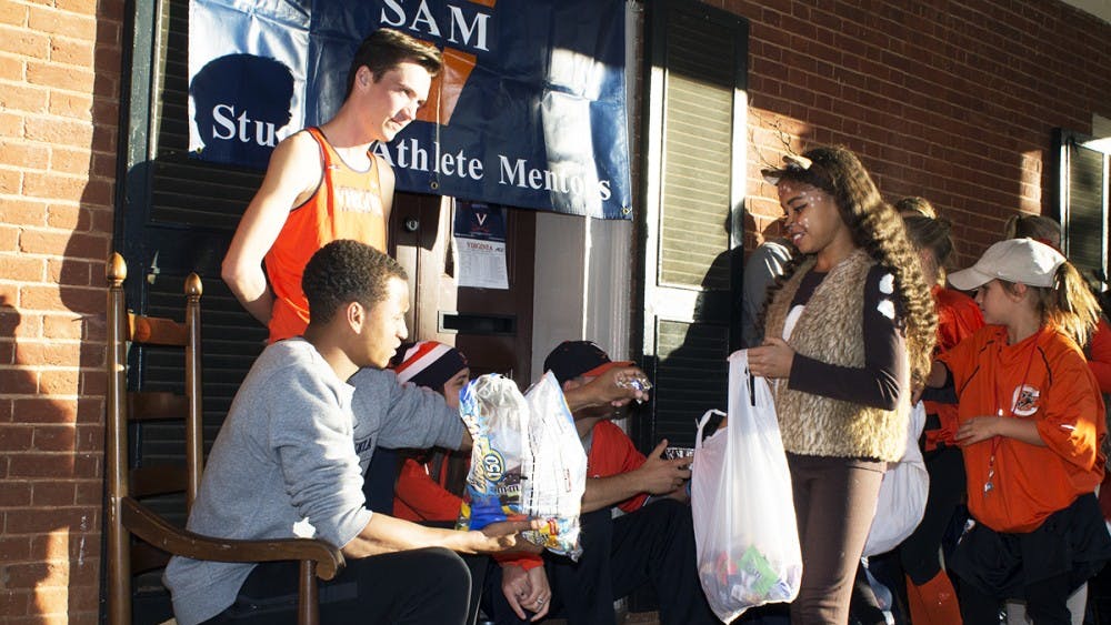 Volunteers on the Lawn pass out candy to trick-or-treaters.
