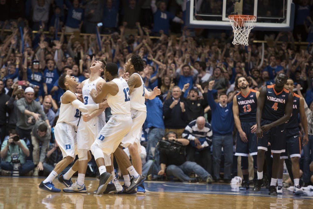 <p>Virginia players look on as Duke celebrates a buzzer-beater by Grayson Allen, which handed the Blue Devils a 63-62 win against the Cavaliers.</p>