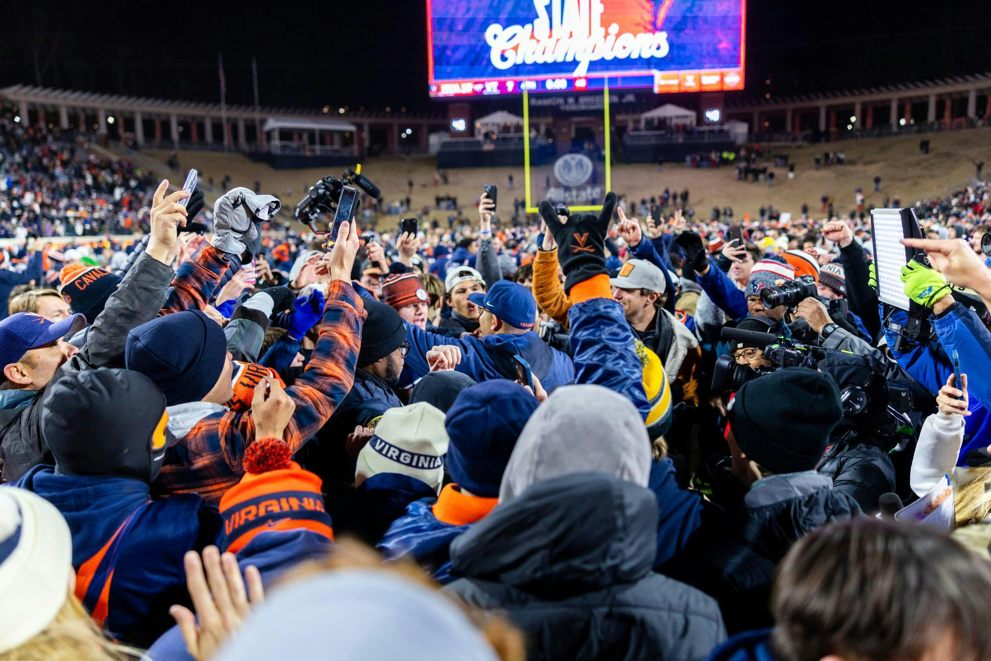 Virginia fans celebrate on the field after beating Virginia Tech.