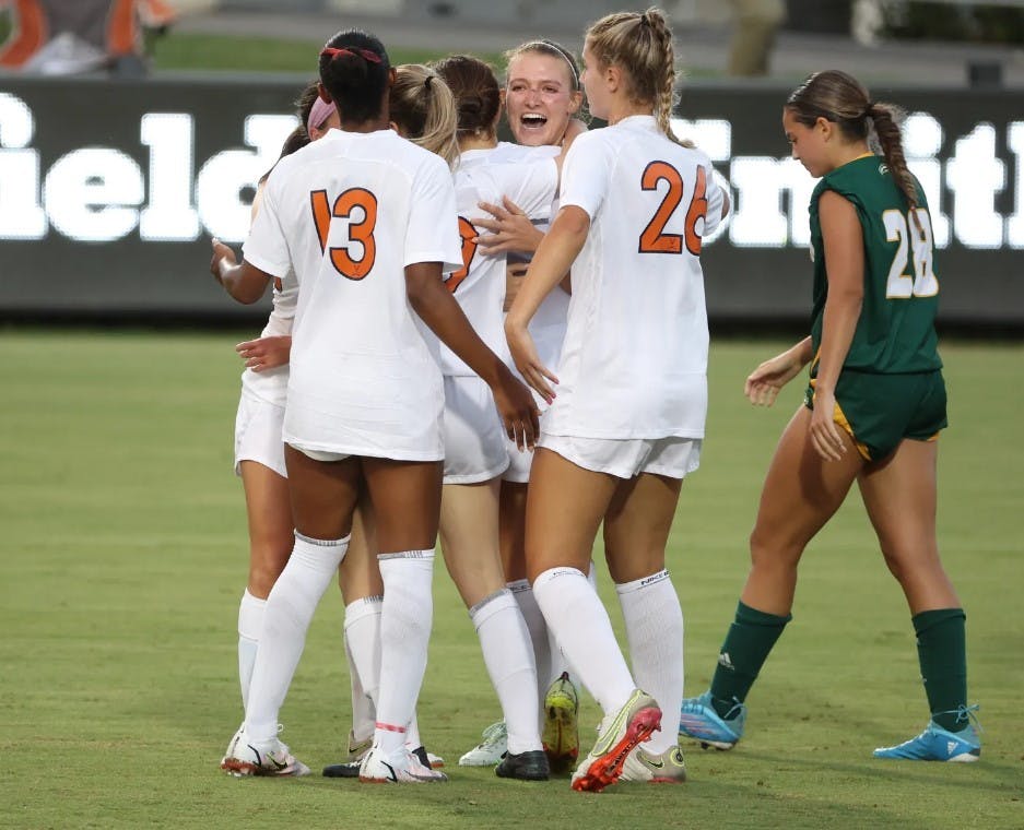 The Cavaliers celebrate after graduate student Alexa Spaanstra notched the first goal of the season for Virginia.