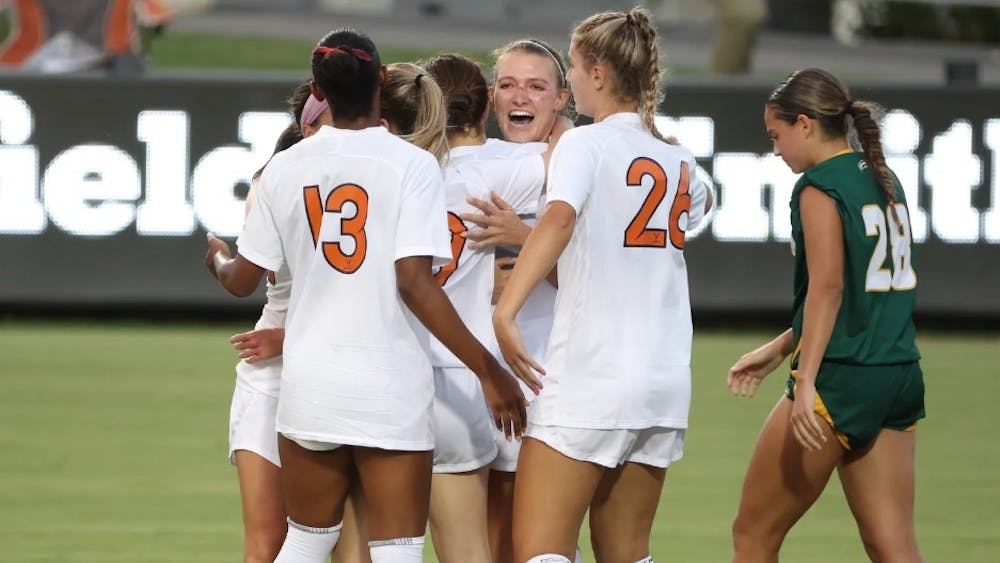 The Cavaliers celebrate after graduate student Alexa Spaanstra notched the first goal of the season for Virginia.
