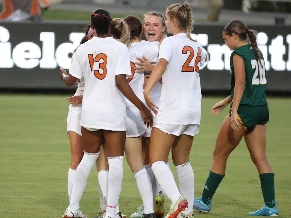 The Cavaliers celebrate after graduate student Alexa Spaanstra notched the first goal of the season for Virginia.