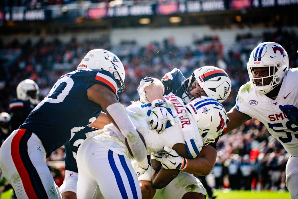 The Cavalier defense converges on senior receiver Roderick Daniels Jr.