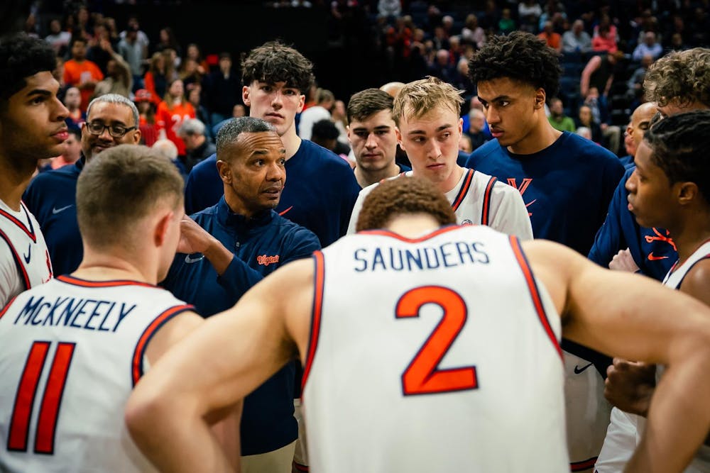 Interim Coach Ron Sanchez conducts the huddle during a timeout.