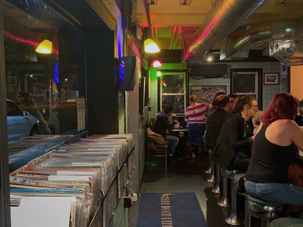  Locals enjoying the laid back atmosphere of Blue Moon, with waitress Tara Bossi serving customers in the back right.