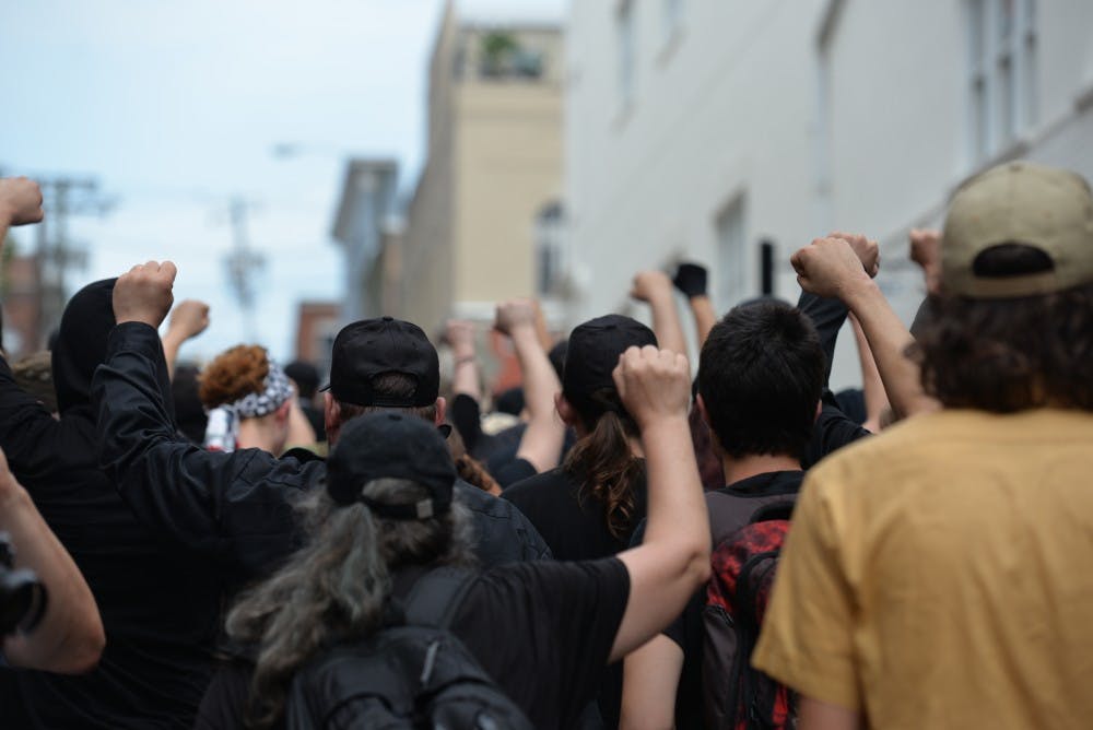The activists marched along the Downtown Mall with fists raised in the air.&nbsp;