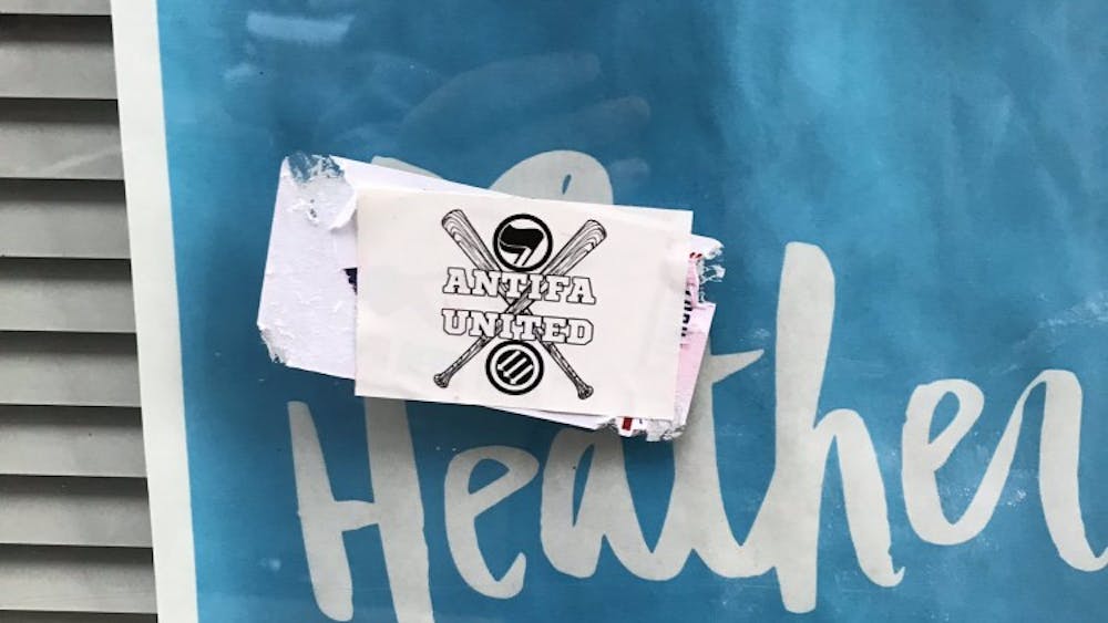 As of Monday evening, the flyers around Heather Heyer Way had been destroyed and replaced with anti-fascist stickers.