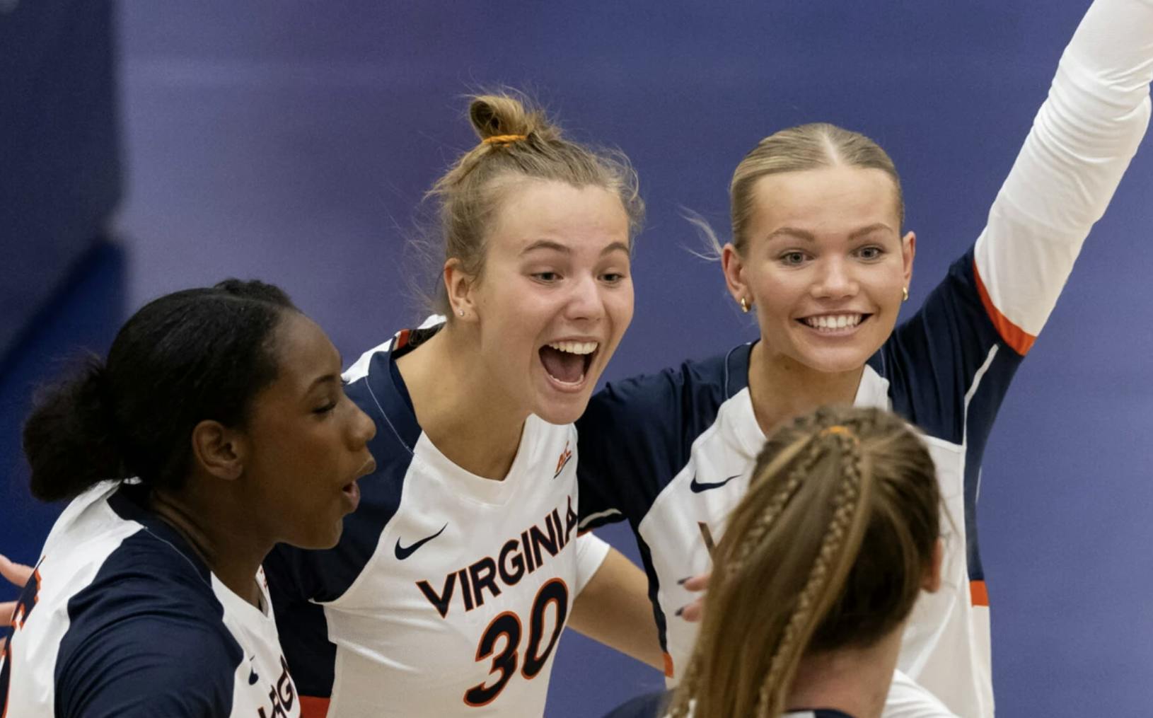 Virginia players celebrate a point during a match earlier this season.