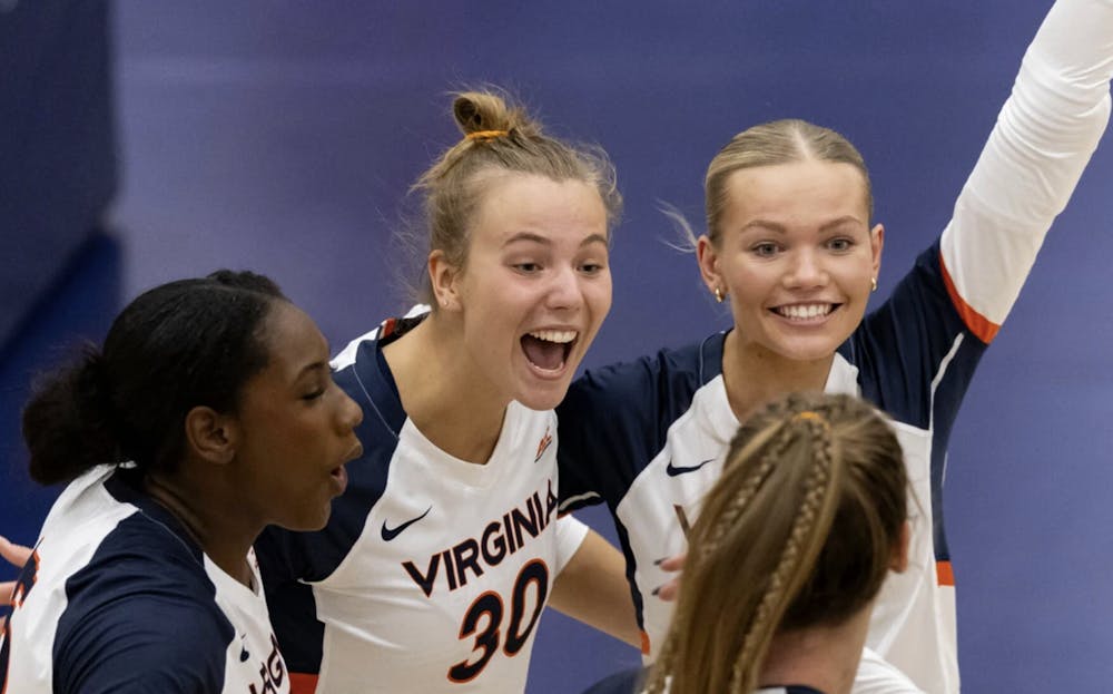 <p>Virginia players celebrate a point during a match earlier this season.</p>