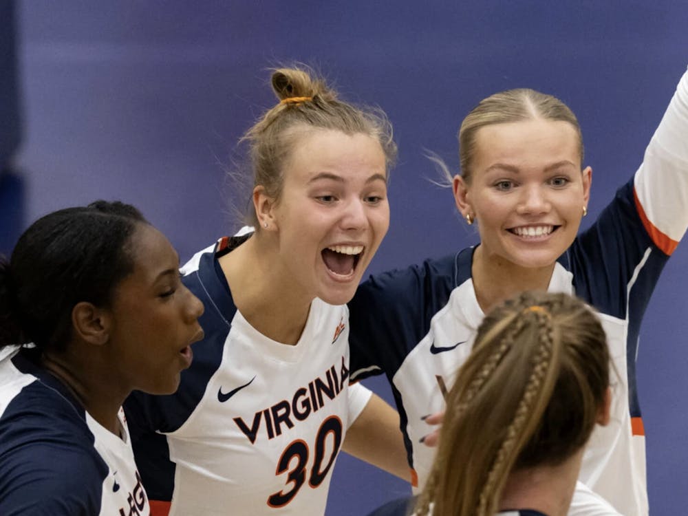 Virginia players celebrate a point during a match earlier this season.