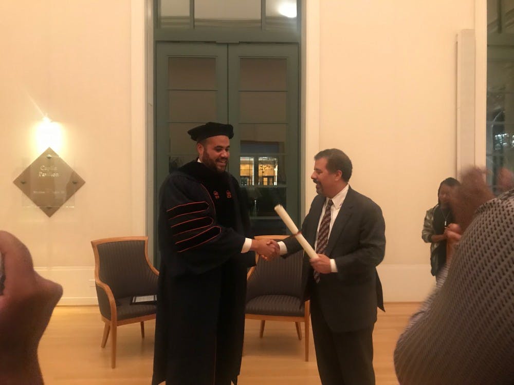 At the conclusion of the event Thursday, Perkins adorned the formal Law School cap and gown he would have worn at graduation and was presented a diploma by Law Prof. Kim Forde-Mazuri, who supported Perkins after the initial incident with police and throughout his trial. 