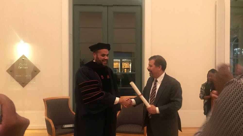 At the conclusion of the event Thursday, Perkins adorned the formal Law School cap and gown he would have worn at graduation and was presented a diploma by Law Prof. Kim Forde-Mazuri, who supported Perkins after the initial incident with police and throughout his trial. 