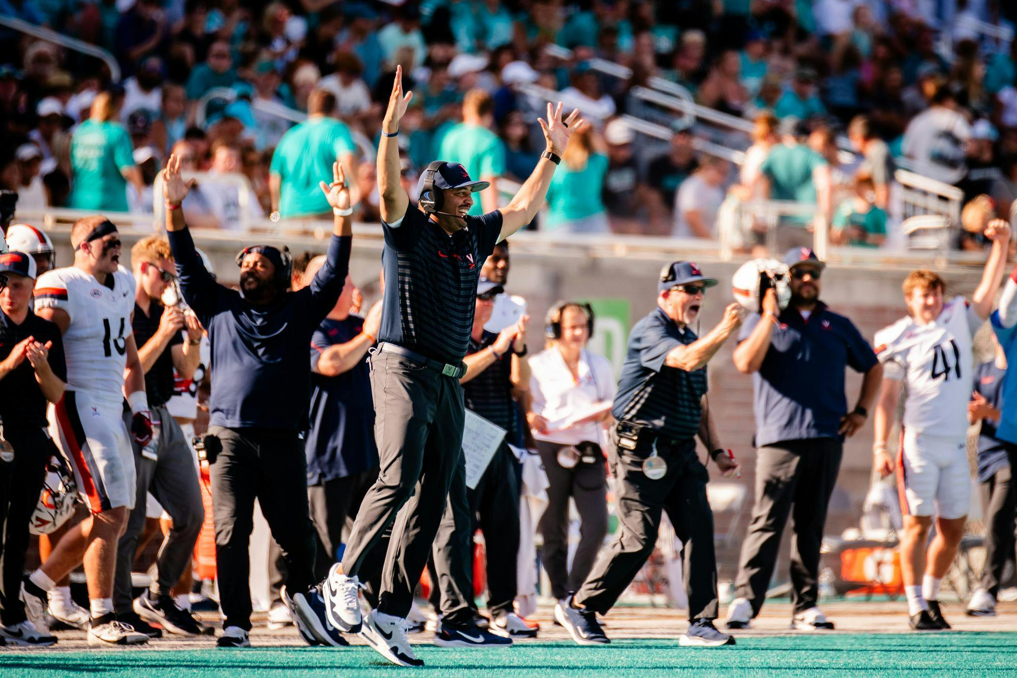 The Virginia sideline celebrates a touchdown at Coastal Carolina last season.