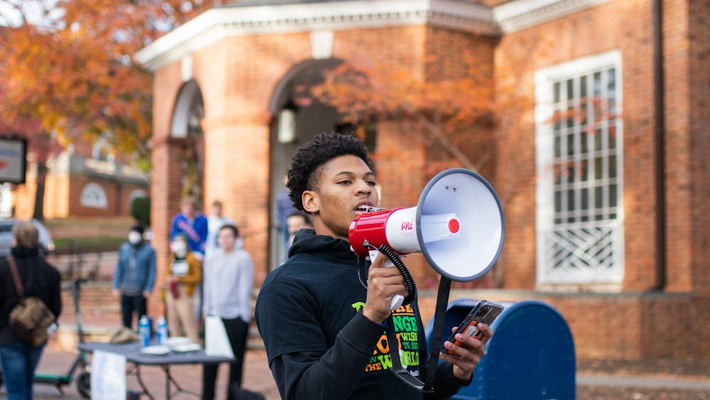 First-year College student Terrell Pittman led chants as the group marched from the Corner to Carr's Hill.&nbsp;