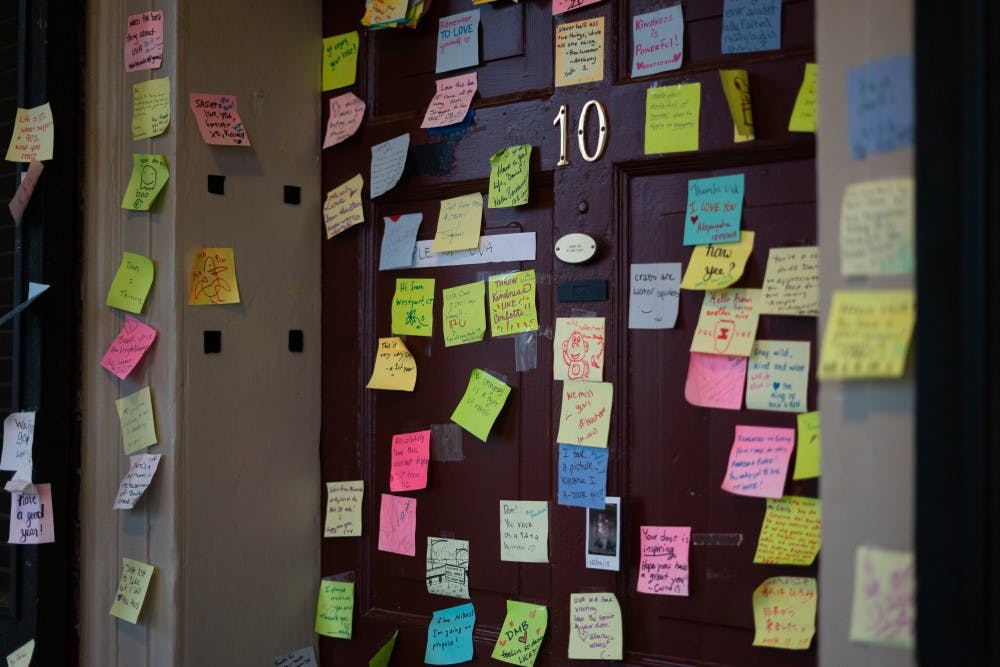 Fourth-year Global Healthy Policy student Dan Xia's Lawn room door is decorated with sticky notes ranging from positive messages to light-hearted doodles.&nbsp;