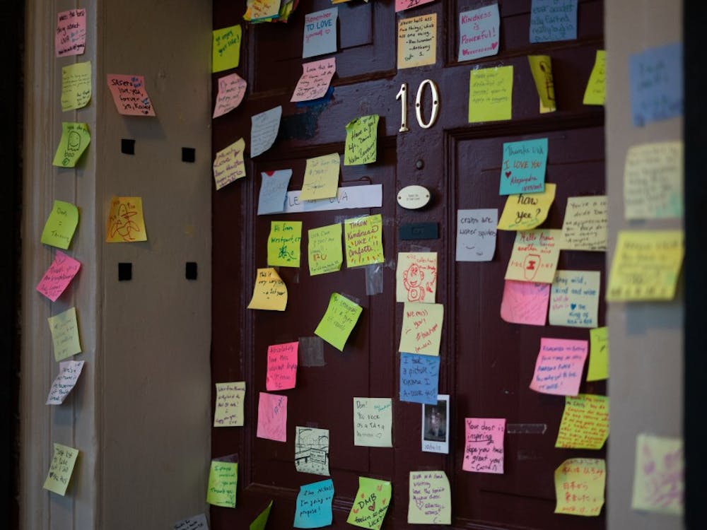 Fourth-year Global Healthy Policy student Dan Xia's Lawn room door is decorated with sticky notes ranging from positive messages to light-hearted doodles.&nbsp;