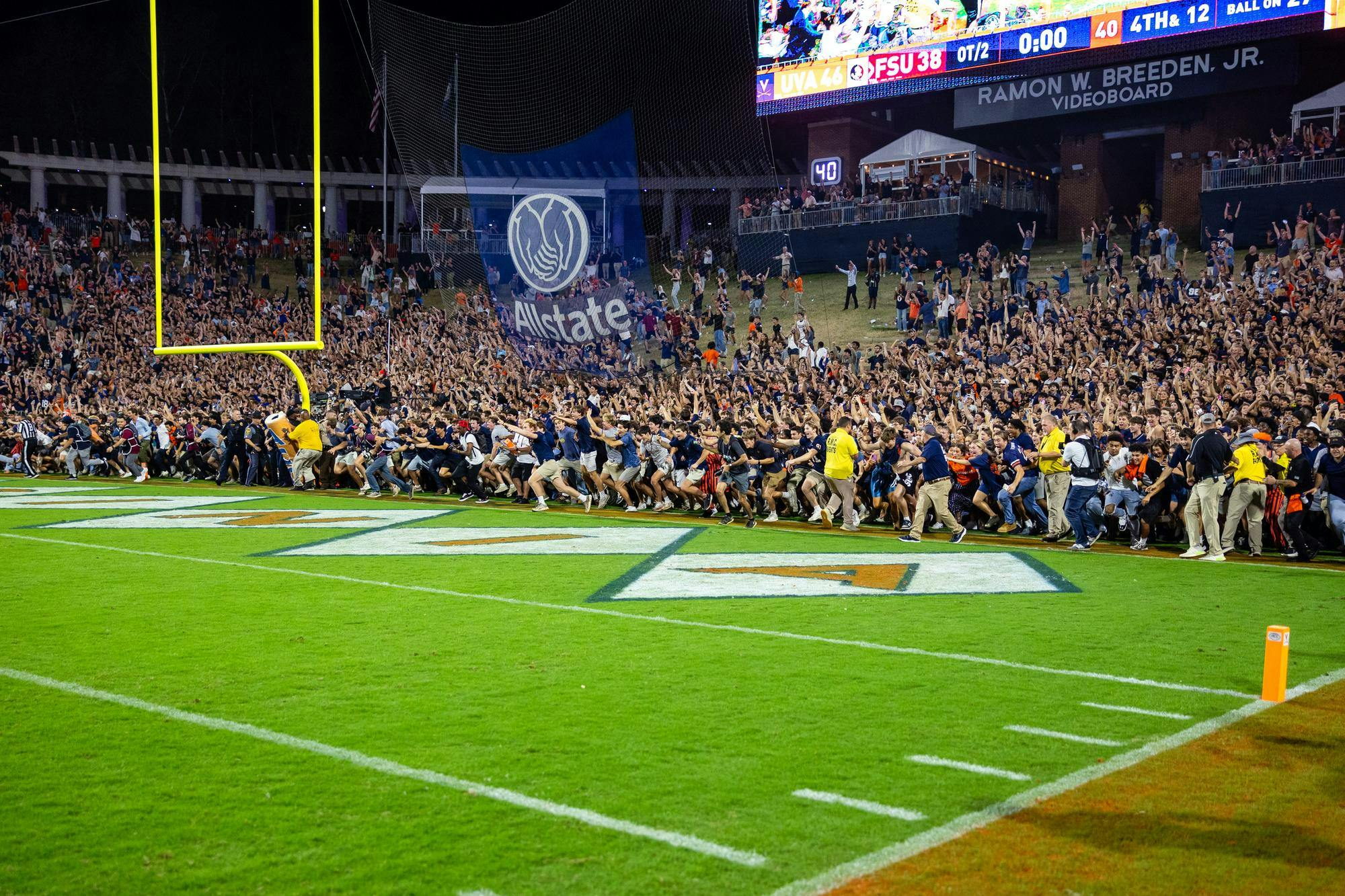 Students flood past ineffectual yellow-shirted guards.