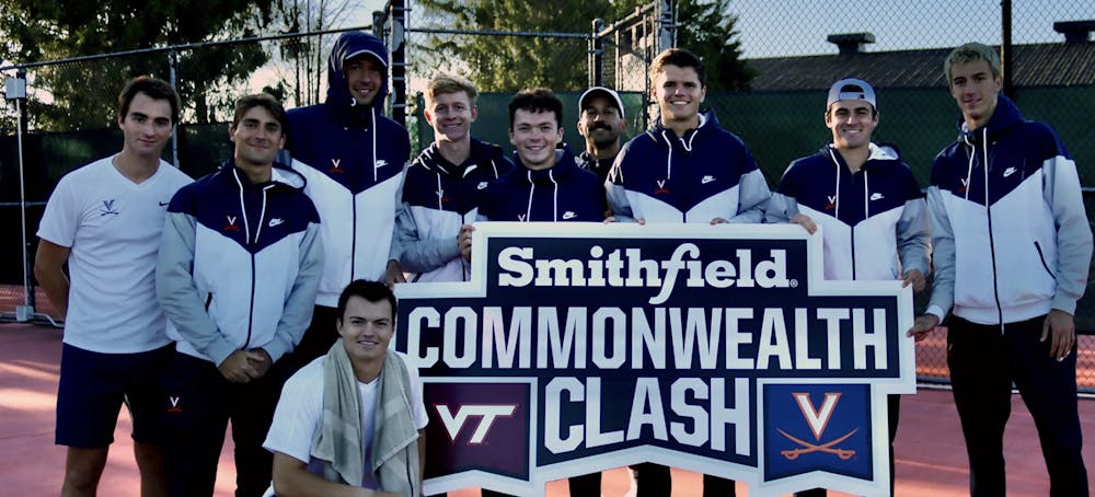 <p>The Cavaliers pose with the Commonwealth Clash sign after defeating the Hokies 6-1 Wednesday.&nbsp;</p>