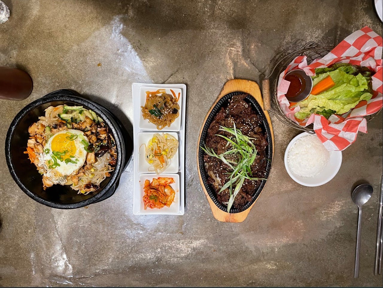 The Dolsot Bibimbap includes your choice of beef, spicy pork, chicken or tofu, rests on a bed of rice topped with an assortment of steaming vegetables that came in a fiery hot stone bowl.