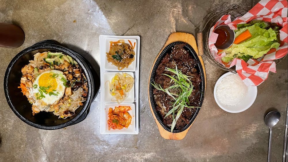 The Dolsot Bibimbap includes your choice of beef, spicy pork, chicken or tofu, rests on a bed of rice topped with an assortment of steaming vegetables that came in a fiery hot stone bowl.