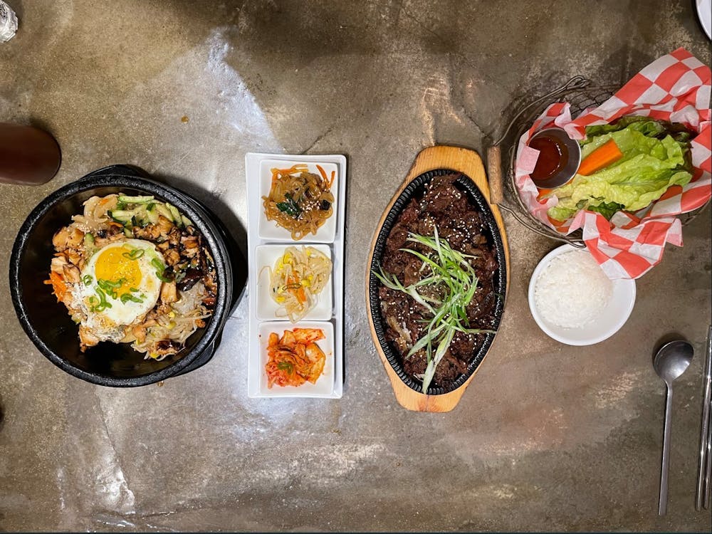 The Dolsot Bibimbap includes your choice of beef, spicy pork, chicken or tofu, rests on a bed of rice topped with an assortment of steaming vegetables that came in a fiery hot stone bowl.