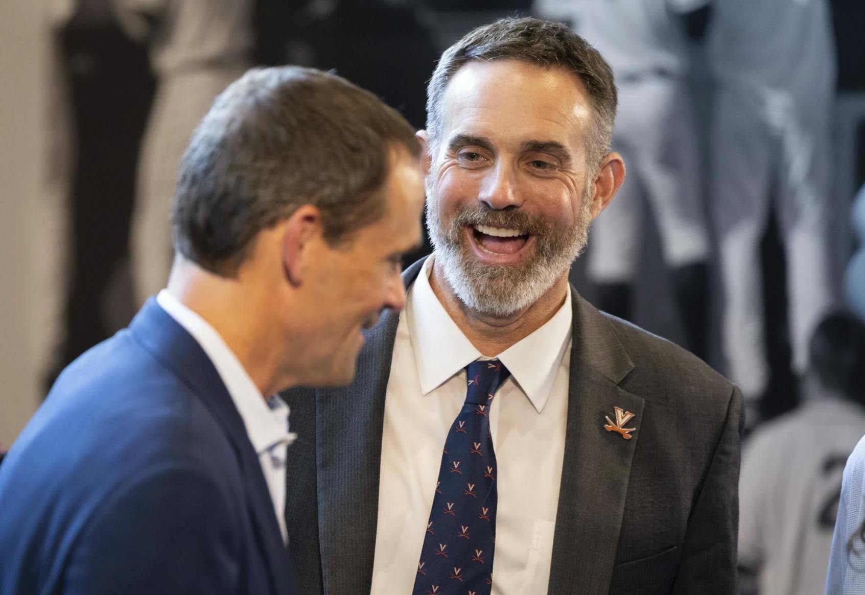 Pollard, donning a Virginia pin and tie, talks with President Jim Ryan.