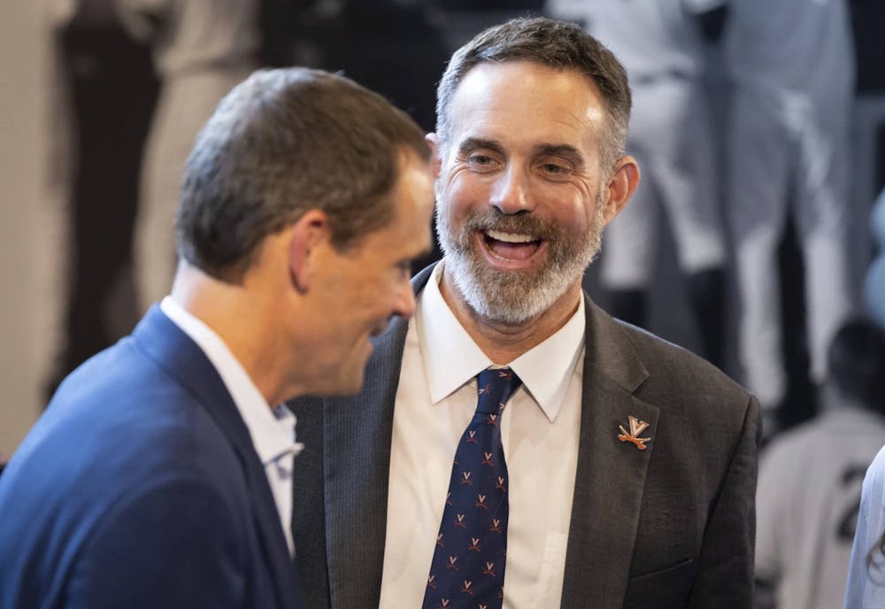 <p>Pollard, donning a Virginia pin and tie, talks with President Jim Ryan.</p>