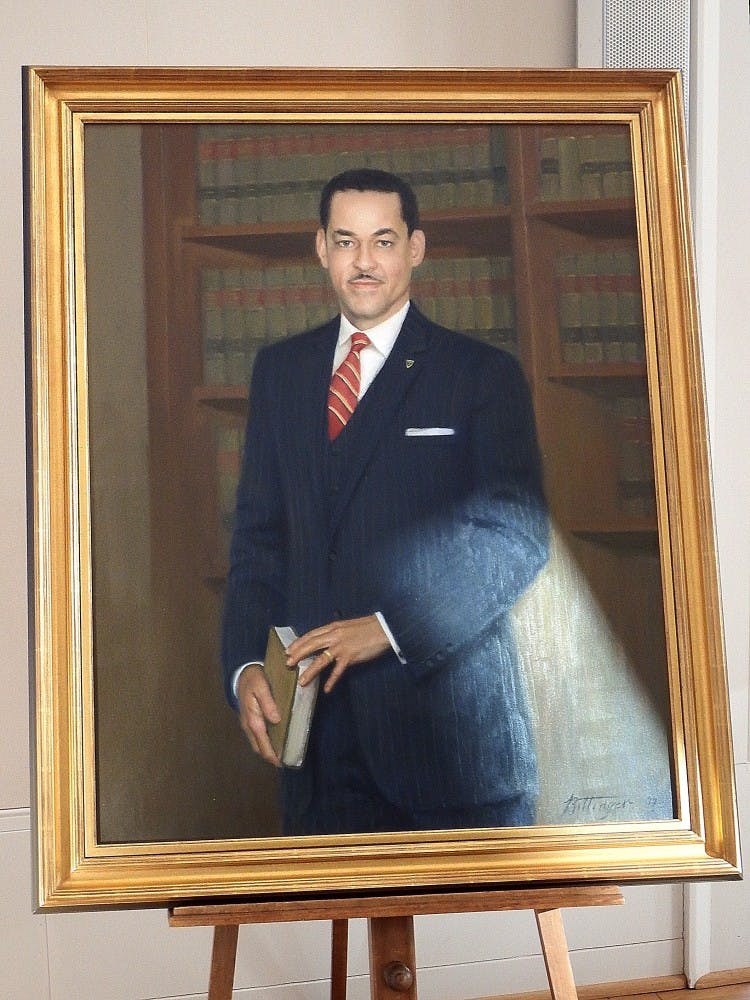 The portrait of Gregory Swanson features a plaque describing his successful lawsuit against the University for admission and his legacy as a the first African-American student and as an attorney.&nbsp;