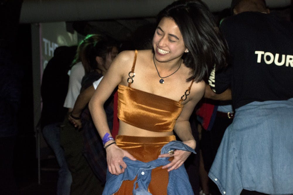 <p>In the center of the dance floor was a girl dancing freely. Her burnt orange velvet two-piece absorbed and reflected the lights around her. &nbsp;</p>