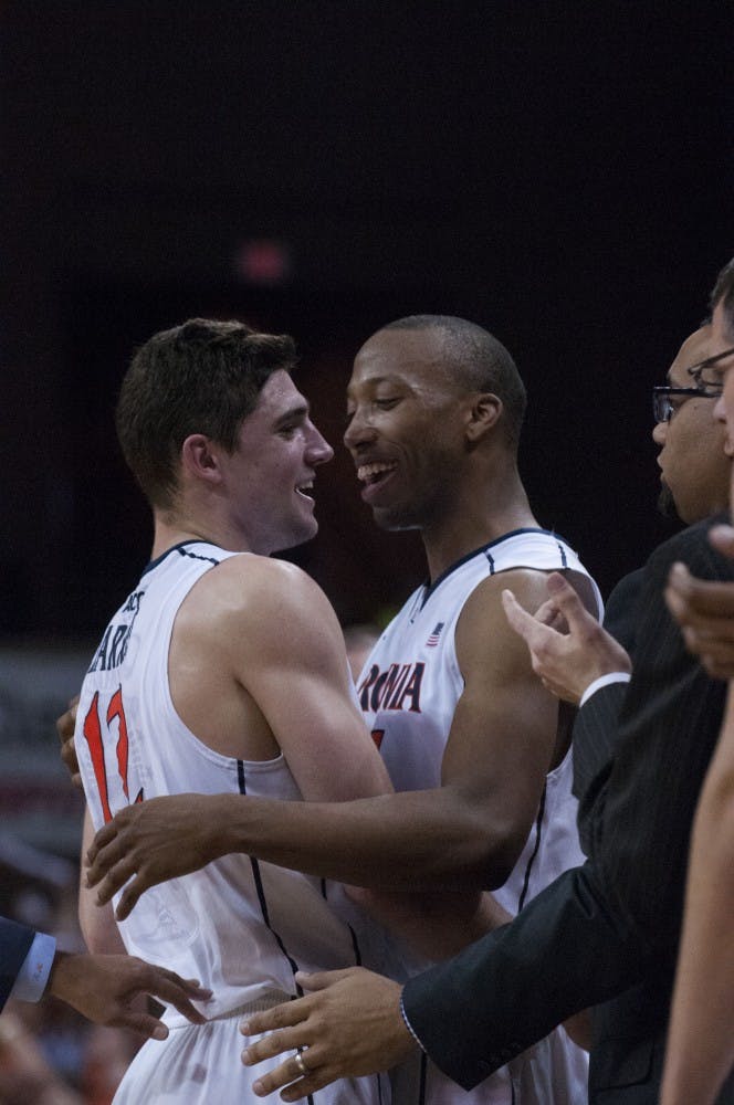 	Seniors Joe Harris and Akil Mitchell, the two remaining players from coach Tony Bennett&#8217;s first recruiting class at Virginia, embrace in Senior Day win against No. 4 Syracuse.