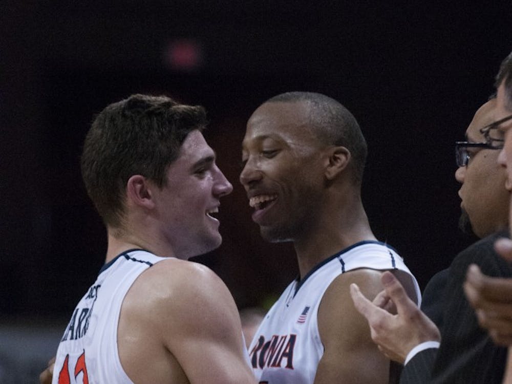 	Seniors Joe Harris and Akil Mitchell, the two remaining players from coach Tony Bennett&#8217;s first recruiting class at Virginia, embrace in Senior Day win against No. 4 Syracuse.