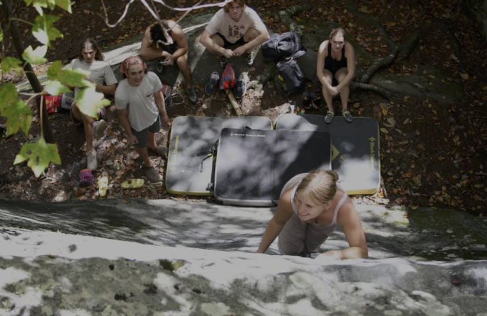 Hannah Russell ascends as her fellow climbers look on.