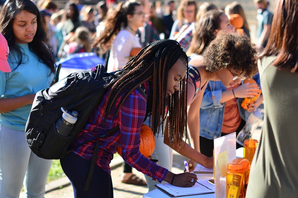 <p>A student signs ADAPT's pledge to practice safe drinking practices.</p>