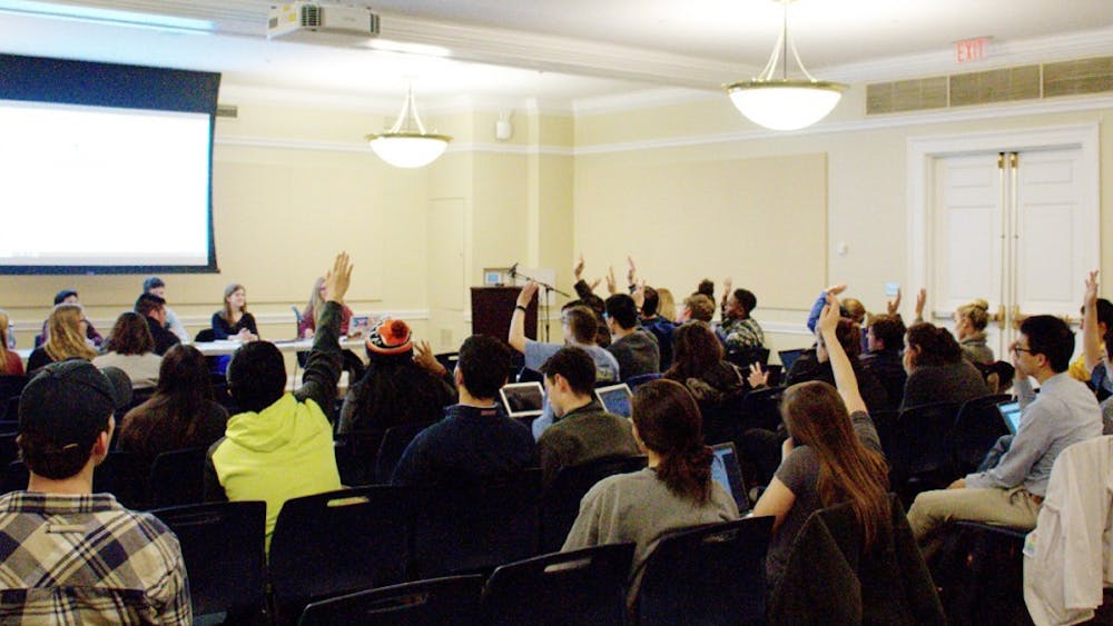 Members of student council voting at a meeting this spring — one of many forms of student self-governance on Grounds.