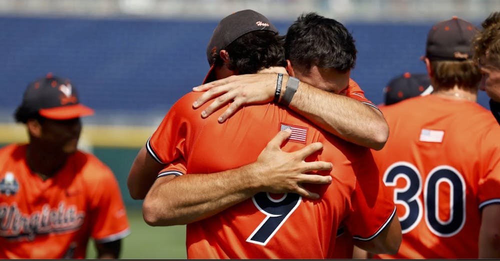 The Cavaliers embrace after being eliminated from the College World Series.