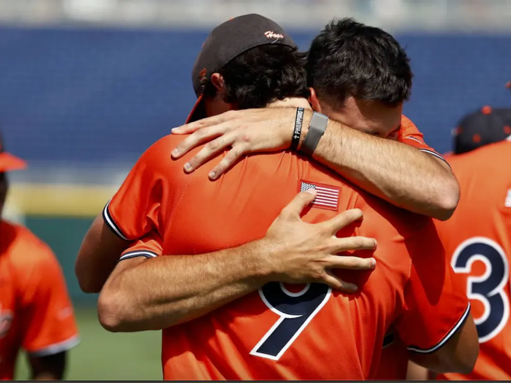 The Cavaliers embrace after being eliminated from the College World Series.