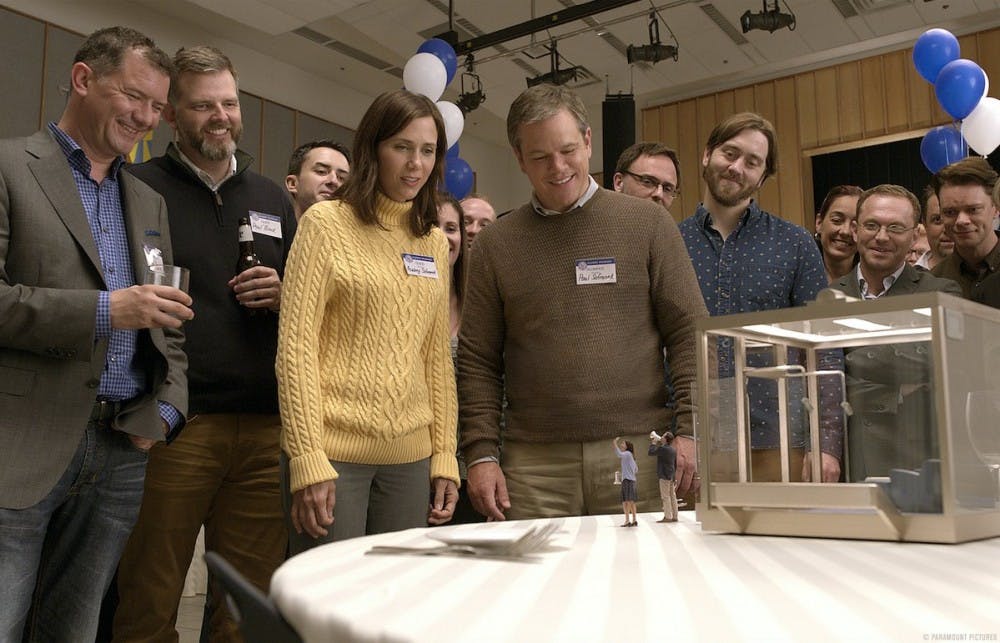 <p>Kristen Wiig (left) and Matt Damon (right) star in the movie "Downsizing," which focuses on a process that shrinks one's body and cost of living.</p>