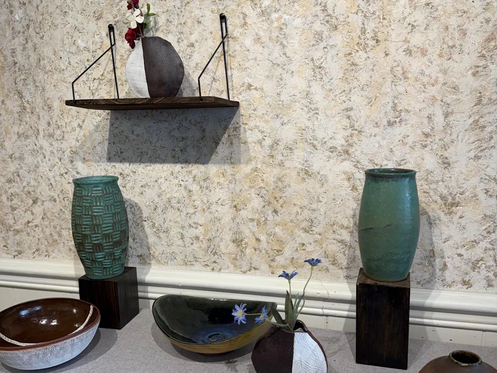 Her works include hand thrown vases, bowls and cups as well as ornate olive oil containers and other ceramic works that express her creative personality and artistic style.