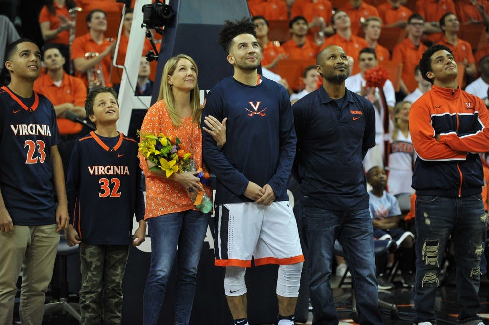Senior point guard London Perrantes stands with his family during Virginia basketball's Senior Day.&nbsp;