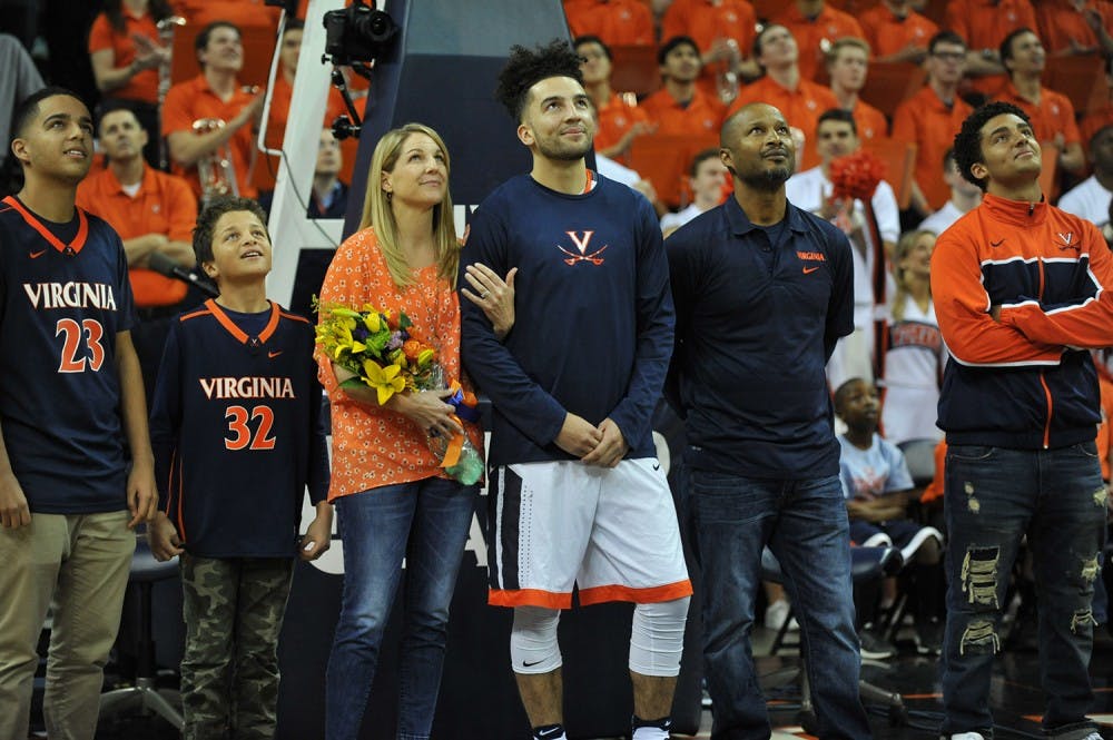 <p>Senior point guard London Perrantes stands with his family during Virginia basketball's Senior Day.&nbsp;</p>