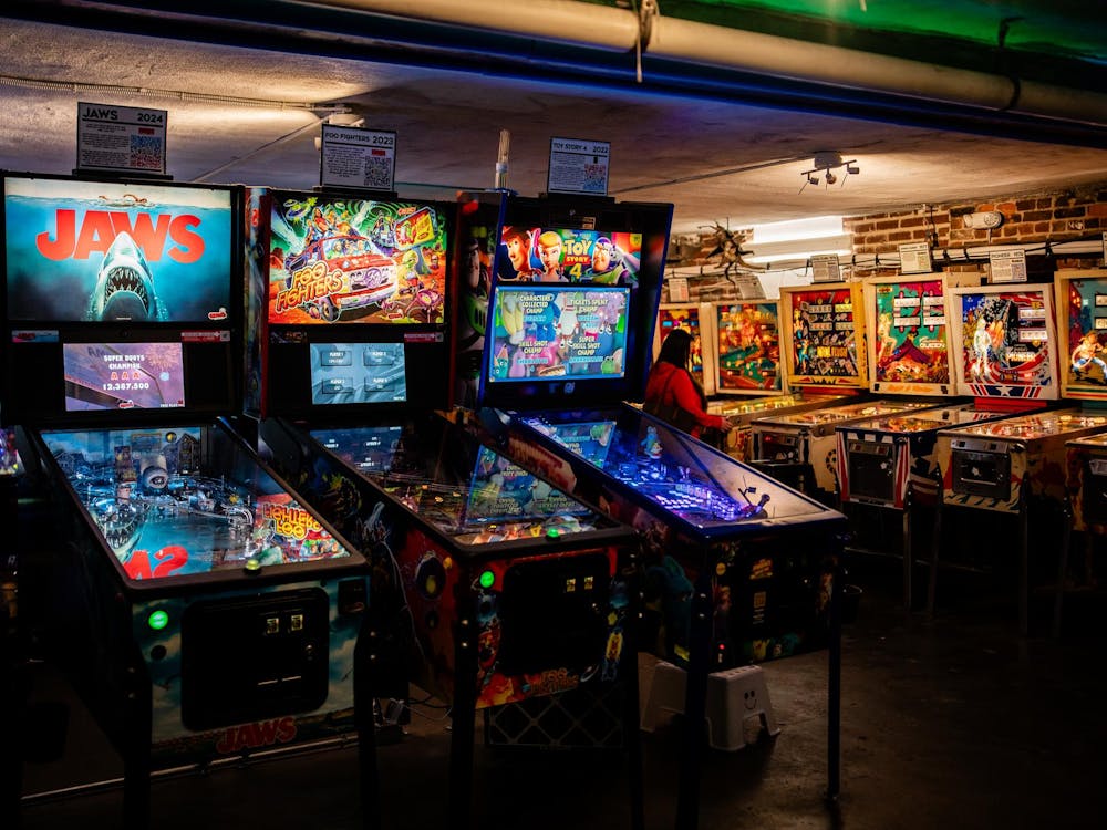 Each pinball machine features a short blurb above it describing its technology and significance