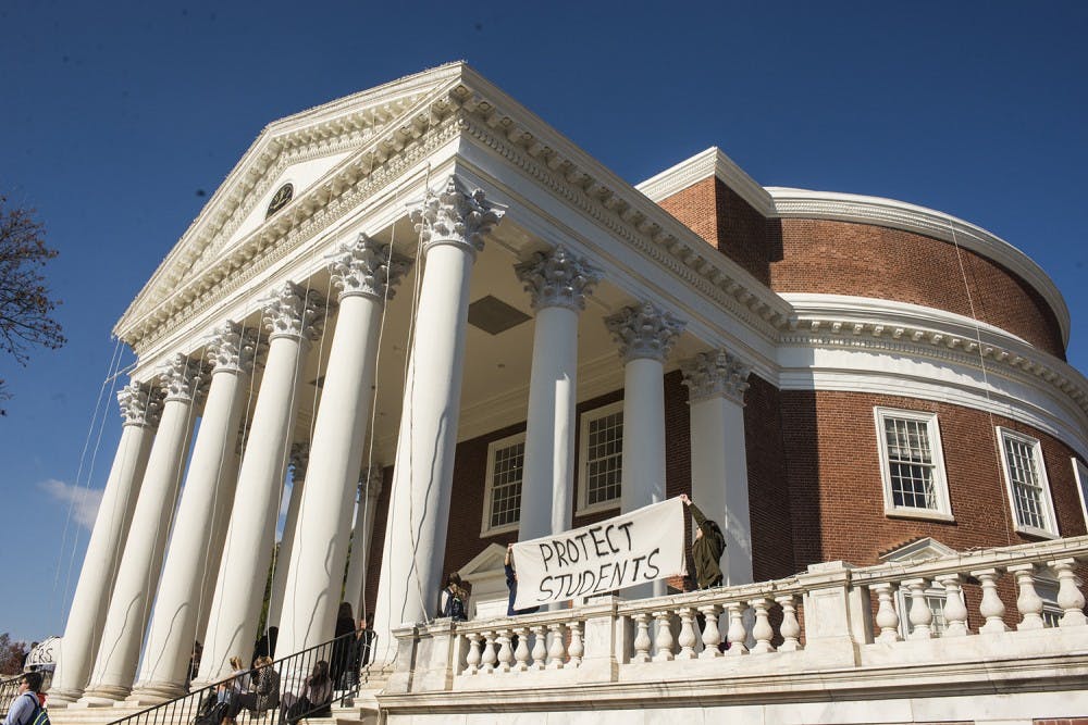 Student protesters held banners outside the Rotunda demanding protection for students and workers.